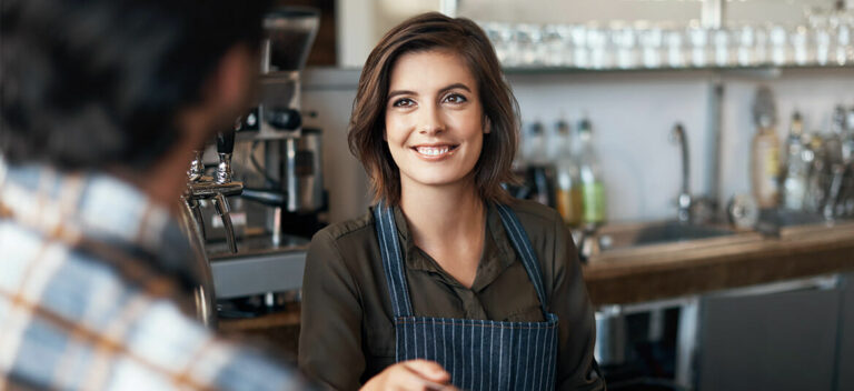 hospitality worker at bar discussing the Australian minimum wage