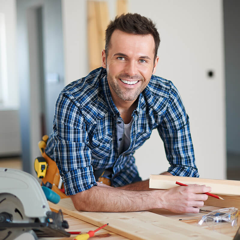 A small business owner working on a woodworking project