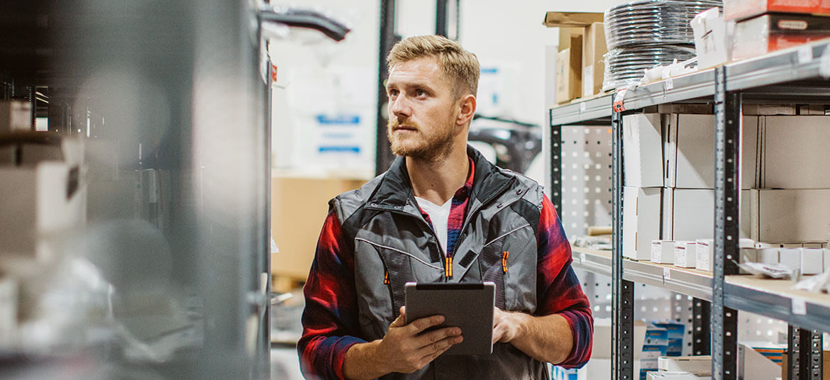 A business owner checking stock and considering his small business growth