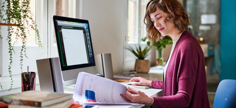 woman at desk choosing between debt finance and equity finance