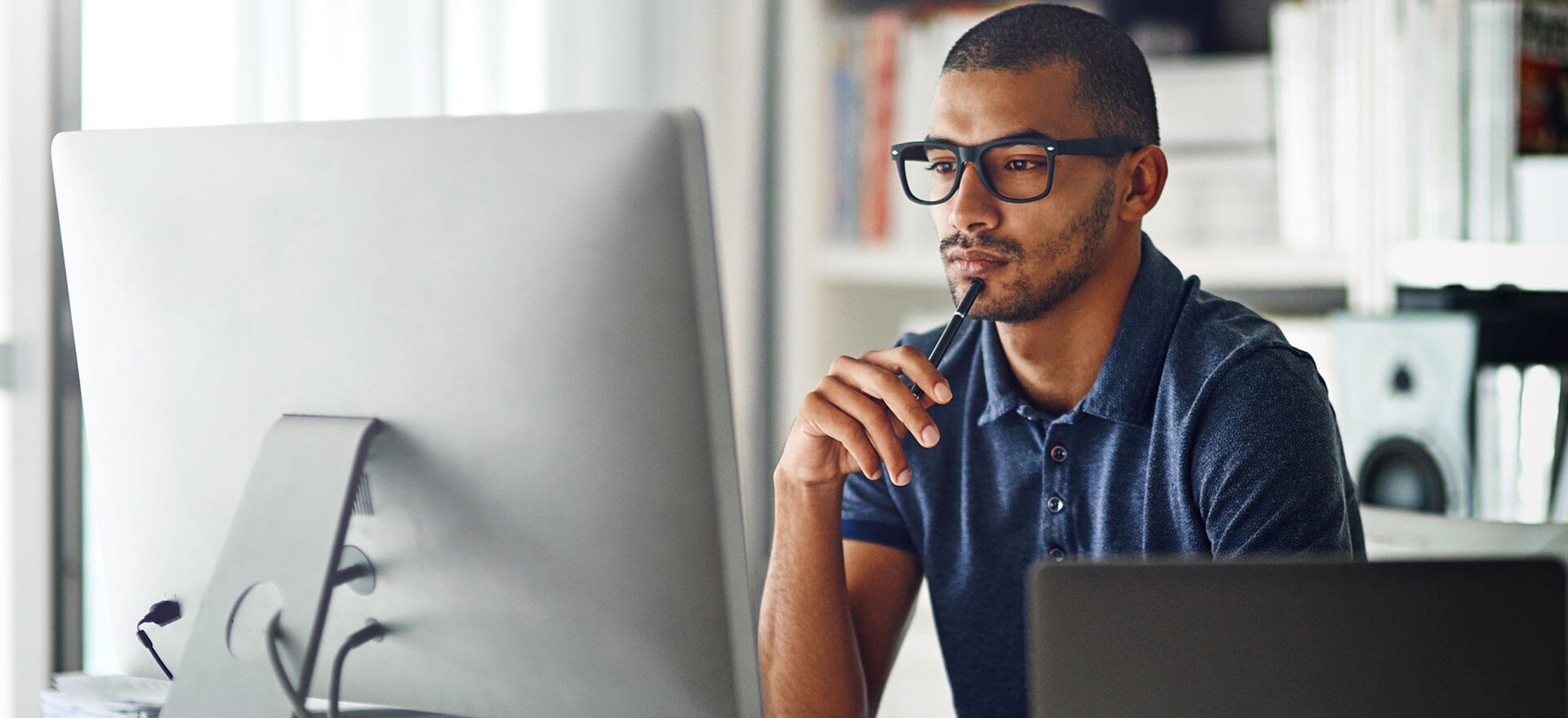 Man at computer comparing business credit card options