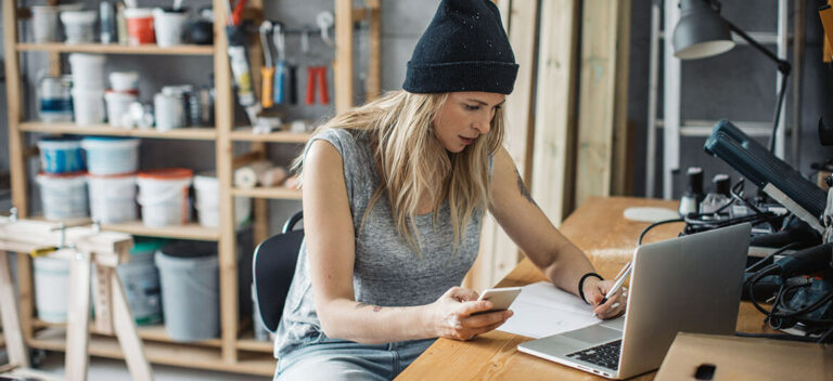 woman sitting at a desk and considering emergency business finance options including an urgent business loan