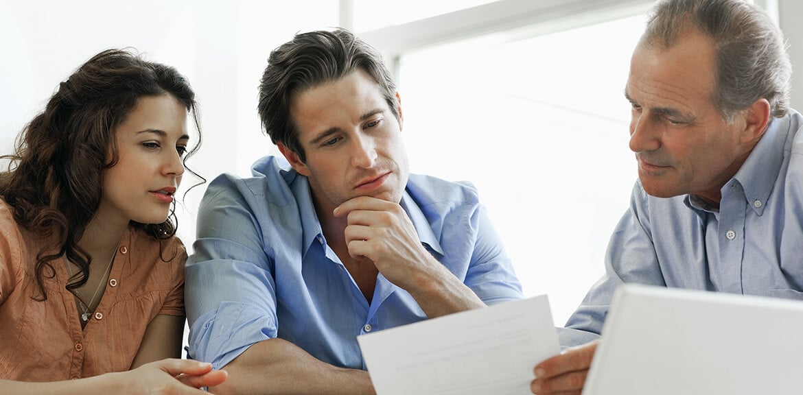 A group of people looking at a various business loan features and how they compare