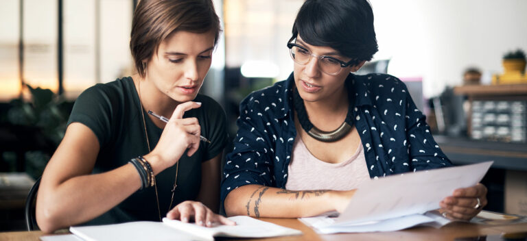Businesswomen discuss a business loan interest rate.