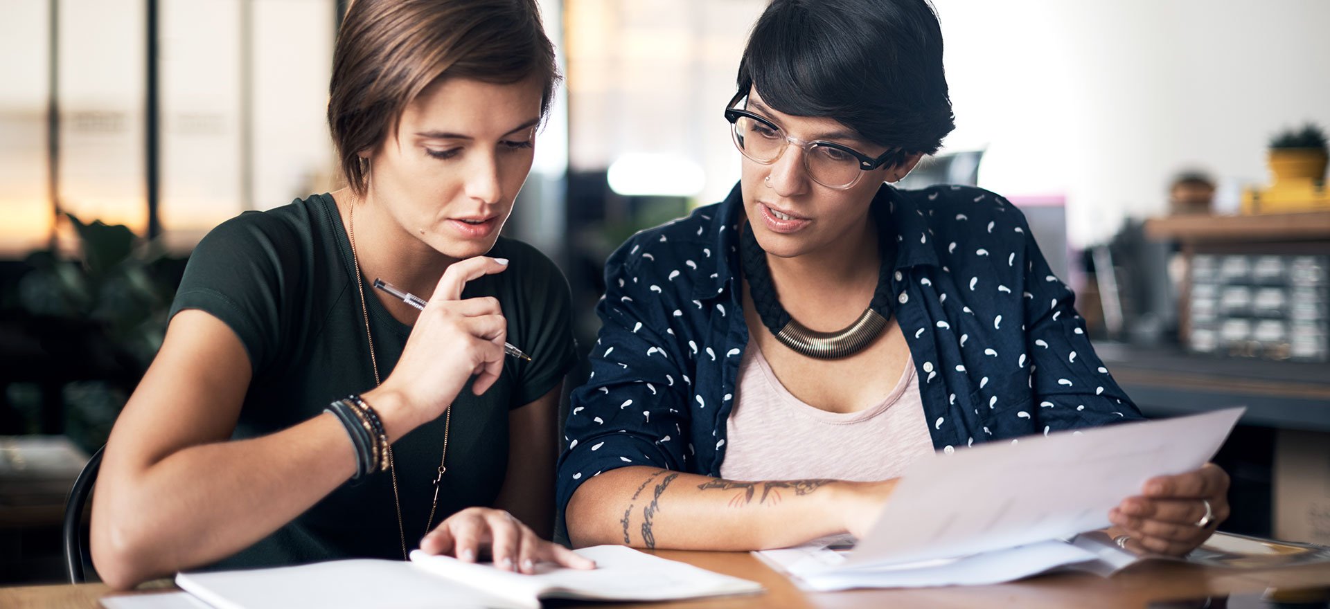 Businesswomen discuss a business loan interest rate.