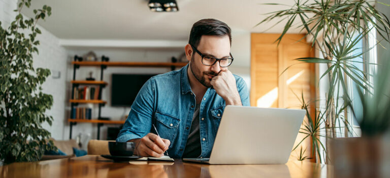 man looking at JobKeeper information on his computer