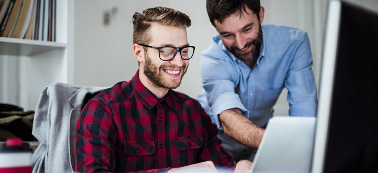 two men at computer discussing risk management