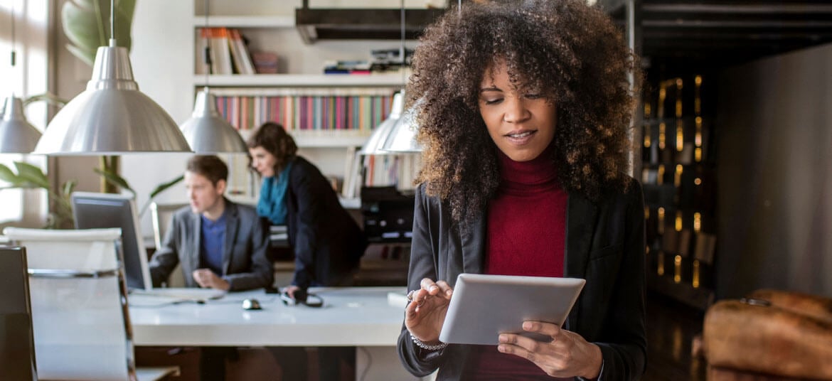 Woman using a tablet to transact with her neobank.