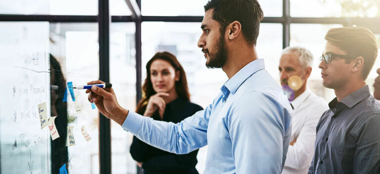 Image of staff conducting a PEST analysis