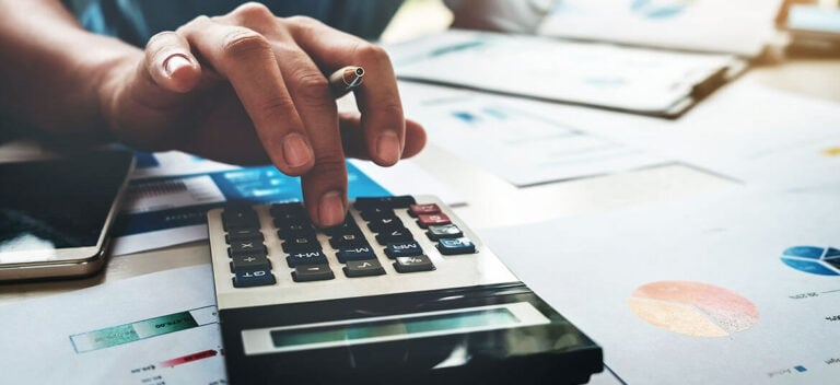 person using calculator for amortisation