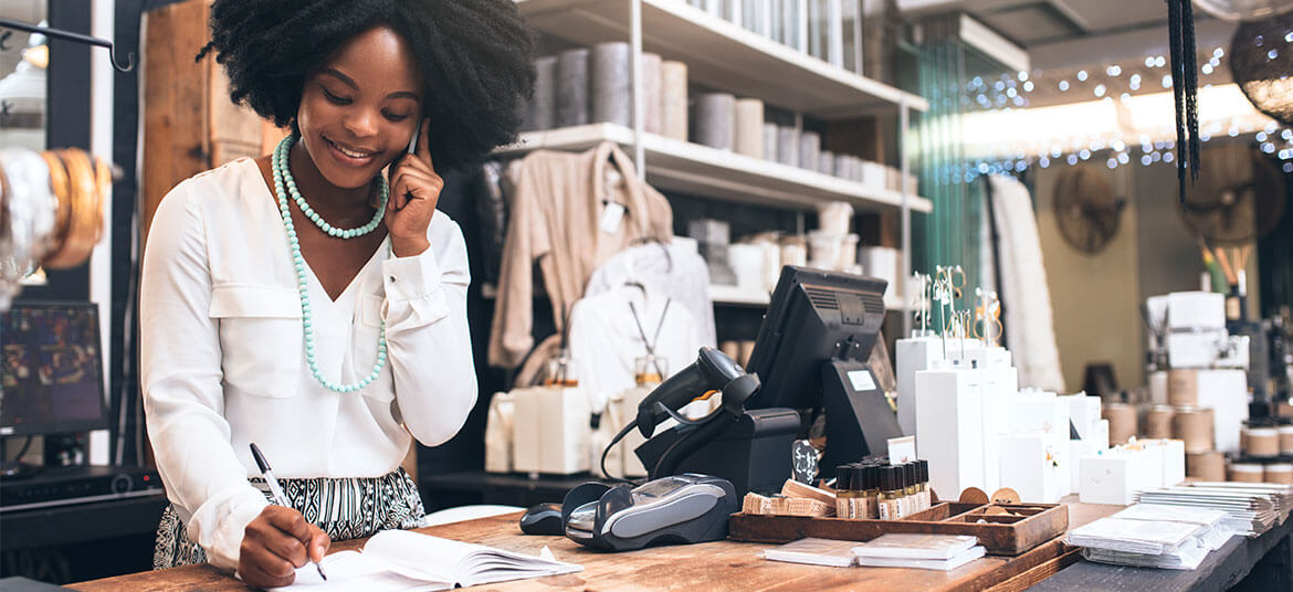 Business woman at a desk considering her cash flow