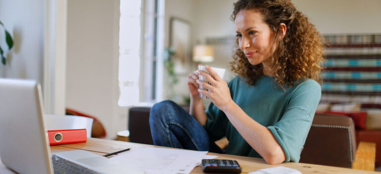 Woman at computer writing a business plan.